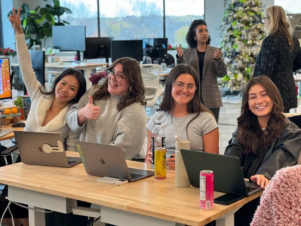 4 girls working at an office desk